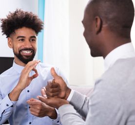Young Black man signing ok to a another man signing help
